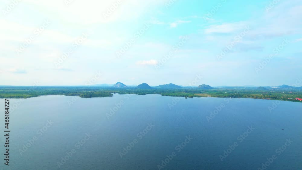 4K Aerial view drone fly over Water reservoir in the countryside of Thailand. Blue sky with clouds and sun, Clouds at Sunrise.
4K Aerial view drone fly over Water reservoir in the countryside of Thailand. Blue sky with clouds and sun, Clouds at Sunrise.
