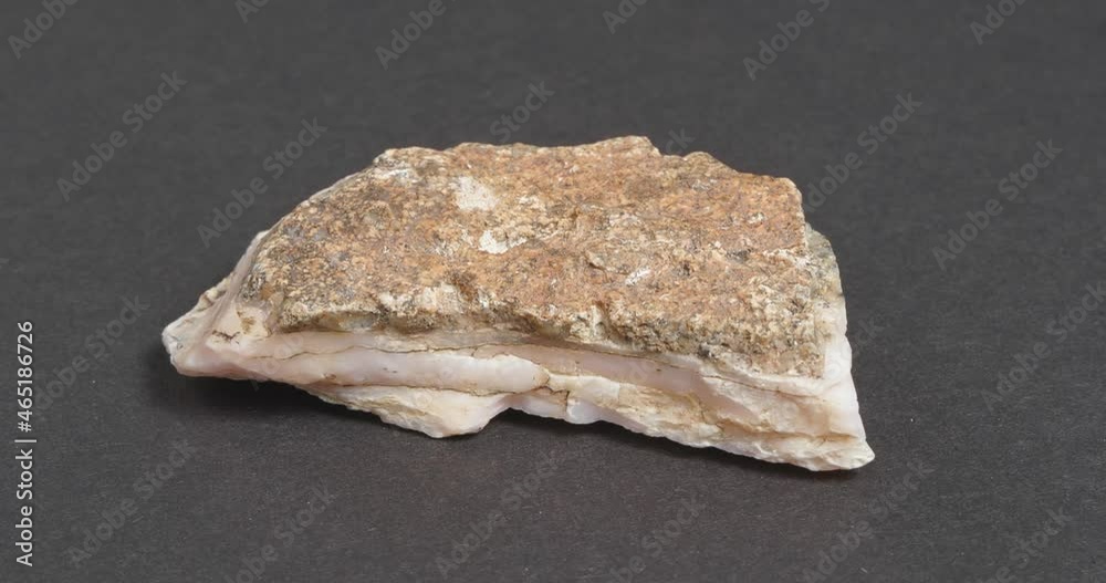 Calcite pink on a dark background. Untreated natural stone.