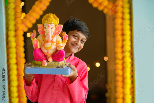 Indian little child celebrate lord ganesha festival.