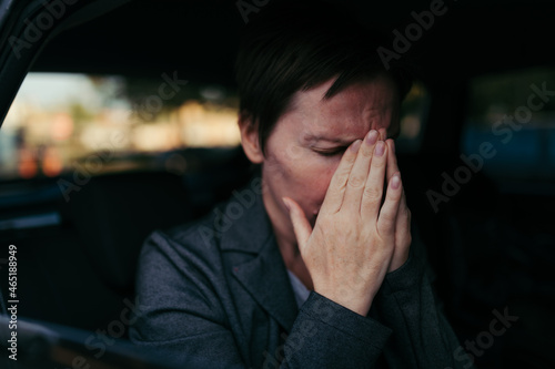 Anxious businesswoman sitting inside of the car