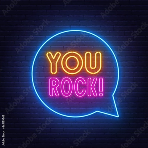 You Rock neon lettering on brick wall background.