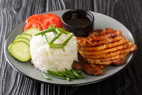 Com Tam Vietnamese Broken Rice with Grilled Pork close-up in a plate on the table. Horizontal