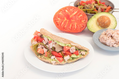 Fajitas with tortilla mix tomato, pepper, tuna onion and avocado on white background