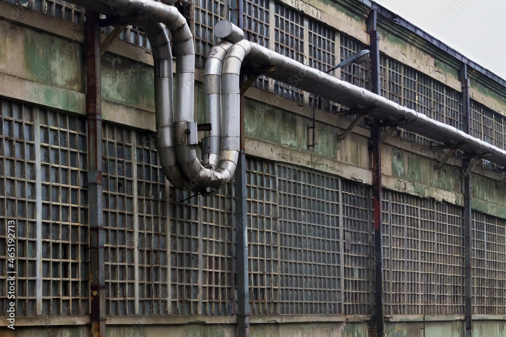 Part of the external facade of the abandoned production hall of the metal industry factory, with part of the ventilation system. Adobe RGB color space. Part of the external facade of the abandoned production hall of the metal industry factory, with part of the ventilation system. Adobe RGB color space.