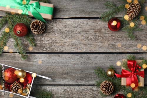 Christmas greeting card with space for text. Flat lay composition of fir tree branches and festive decor on wooden background