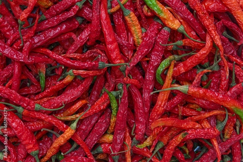 dried green chilli and peppers turns into red colour top view, selective focus