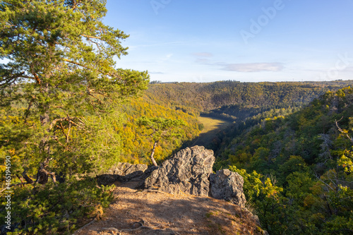 Rocky viewpoint over valley and colorful autumn forests