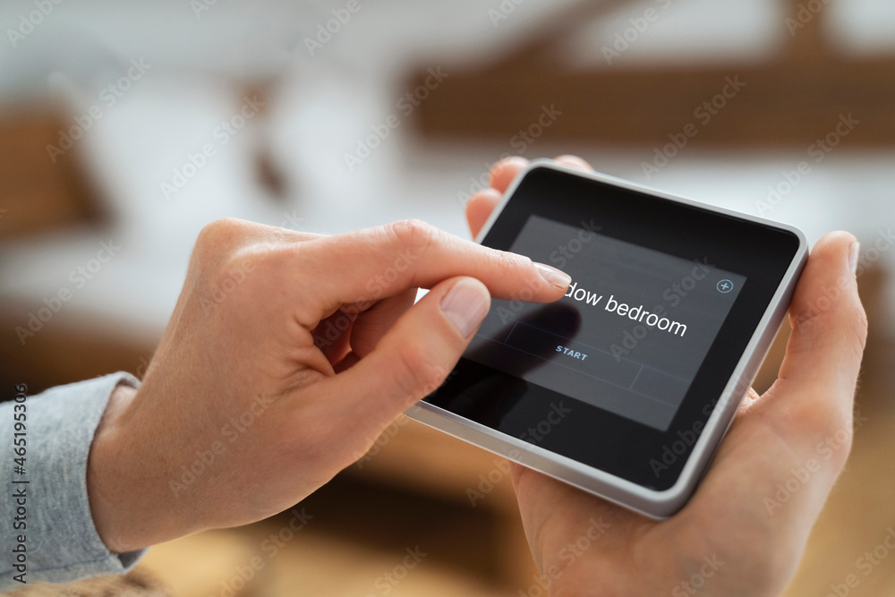 Woman using touch screen smart home device Woman using touch screen smart home device