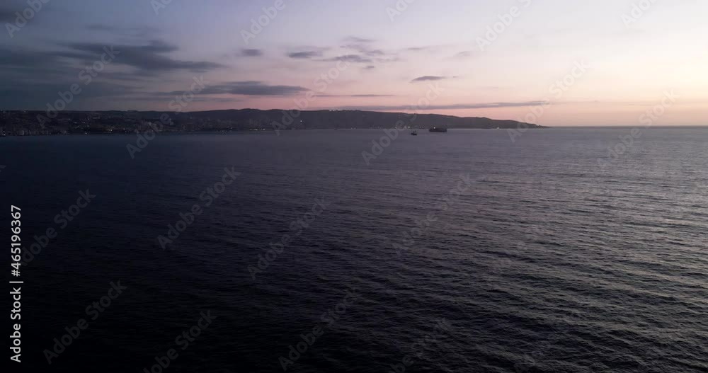 Aerial view of a sunset at sea with Valparaiso in the background Aerial view of a sunset at sea with Valparaiso in the background
