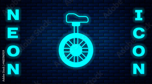 Glowing neon Unicycle or one wheel bicycle icon isolated on brick wall background. Monowheel bicycle. Vector