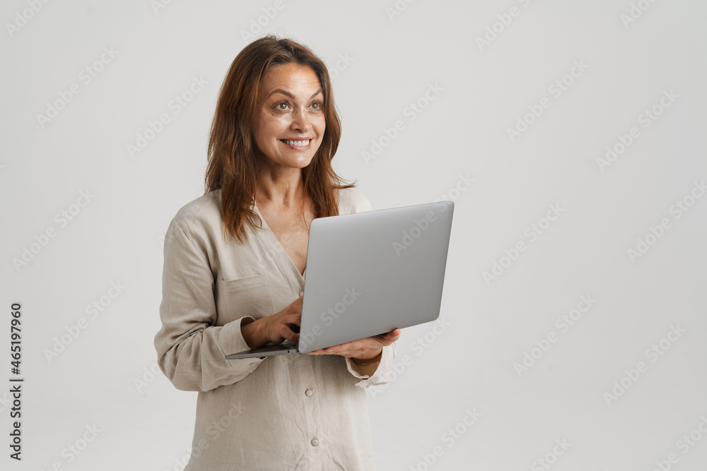 European ginger woman smiling while using laptop European ginger woman smiling while using laptop