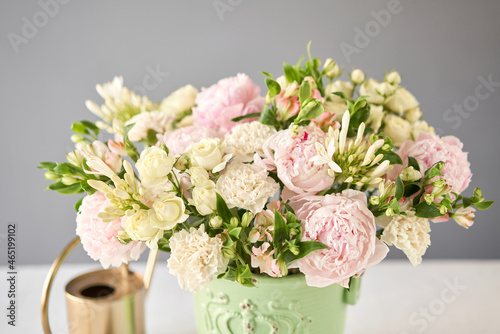Beautiful flower arrangement in a green ceramic vase. Flowers bunch, set for interior. Fresh cut flowers for decoration home. European floral shop. Delivery fresh cut flower.v