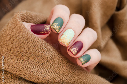 Beautiful matte muted color nails close-up, glittery nail art manicure. photo