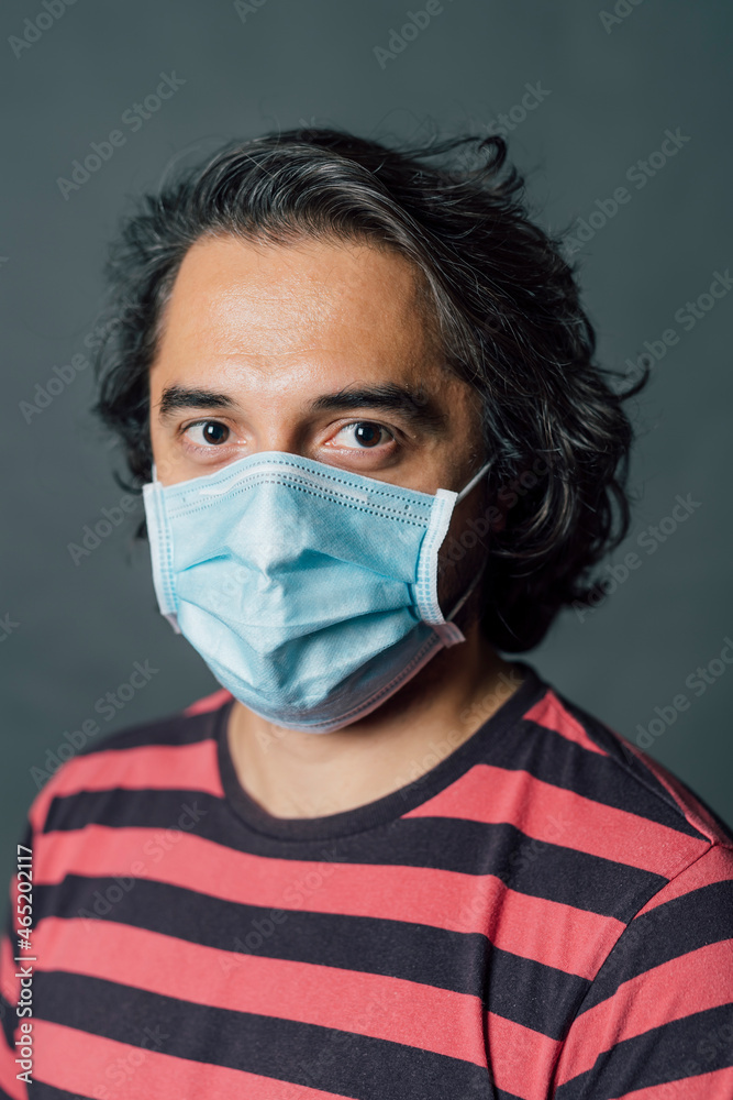 Man in striped t-shirt wearing protective face mask during COVID-19 Man in striped t-shirt wearing protective face mask during COVID-19