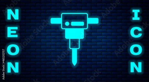 Glowing neon Construction jackhammer icon isolated on brick wall background. Vector