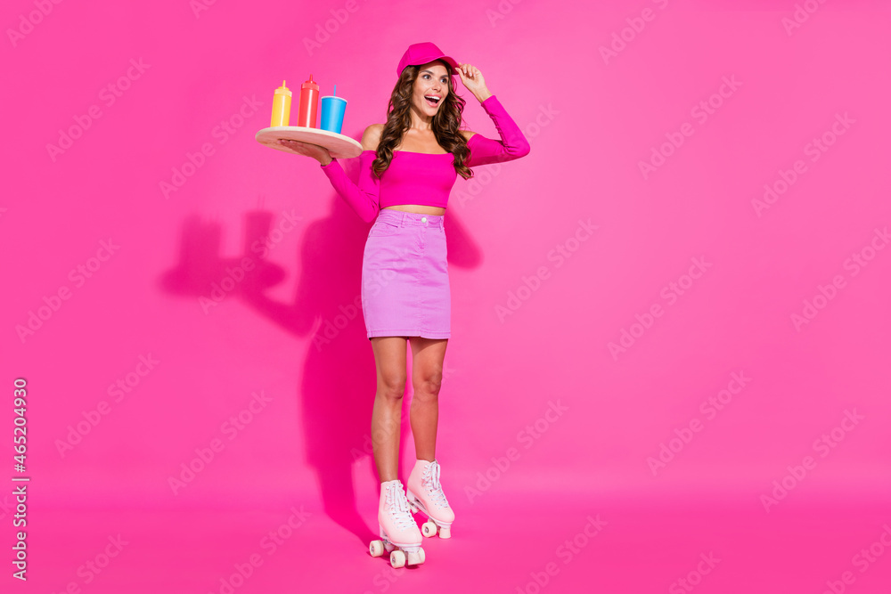 Full length body size view of pretty cheery thin girl delivering sause riding rollers isolated over bright pink color background Full length body size view of pretty cheery thin girl delivering sause riding rollers isolated over bright pink color background