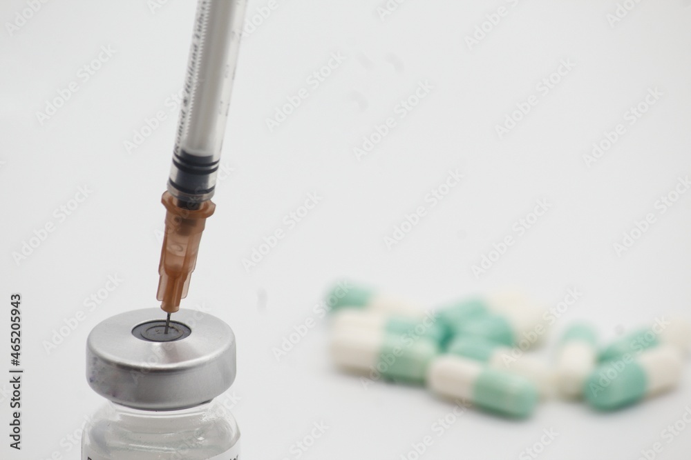 syringe and pills on white background syringe and pills on white background