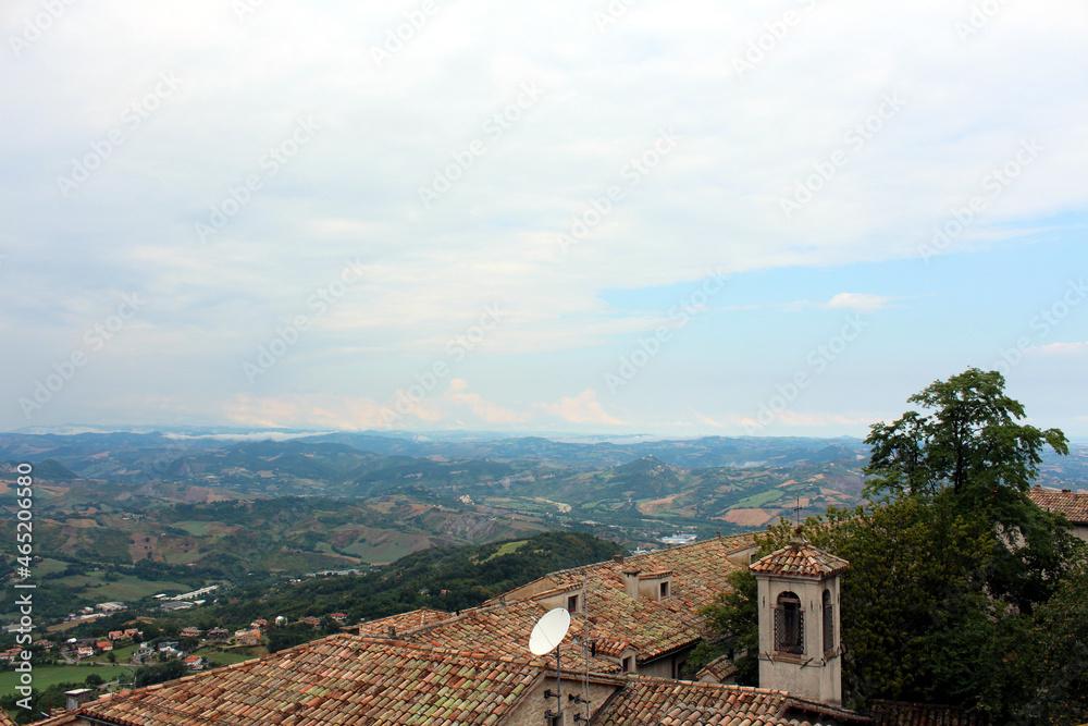 View of the tiled roofs of houses and the foothills of San Marino