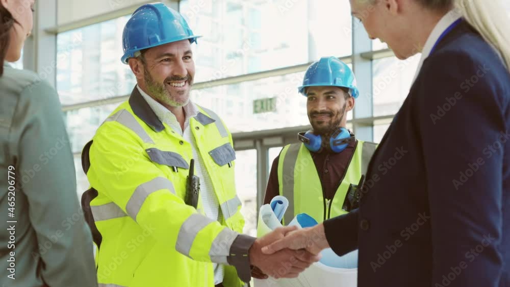 Mature architect and contractor shaking hands at construction site