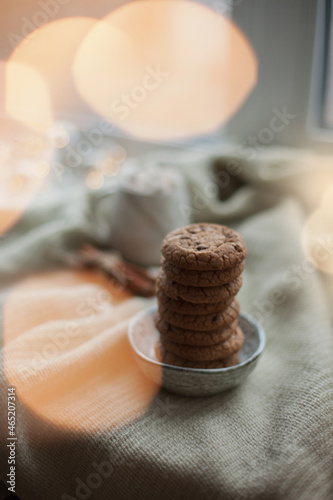 Chocolate chip cookies on a small plate with christmas lights bokeh