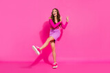 Full length body size view of attractive cheerful thin girl dancing moving having fun isolated over bright pink color background