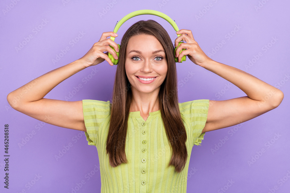 Photo of cheerful positive woman put head headphones music lover smile isolated on violet color background Photo of cheerful positive woman put head headphones music lover smile isolated on violet color background