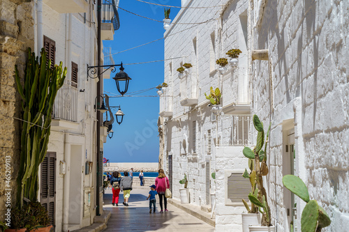 Narrow walkway between white buildings. Italy, Apulia, Metropolitan City of Bari, Monopoli, Puglia, Italy