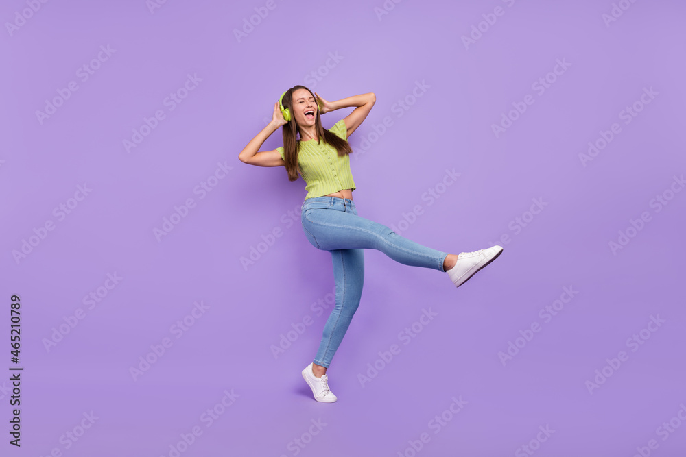 Full length body size view of pretty overjoyed carefree cheerful girl listening rock dancing isolated over purple violet color background