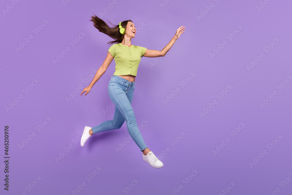 Full length body size view of pretty cheerful girl jumping listening sound having fun isolated over purple violet color background