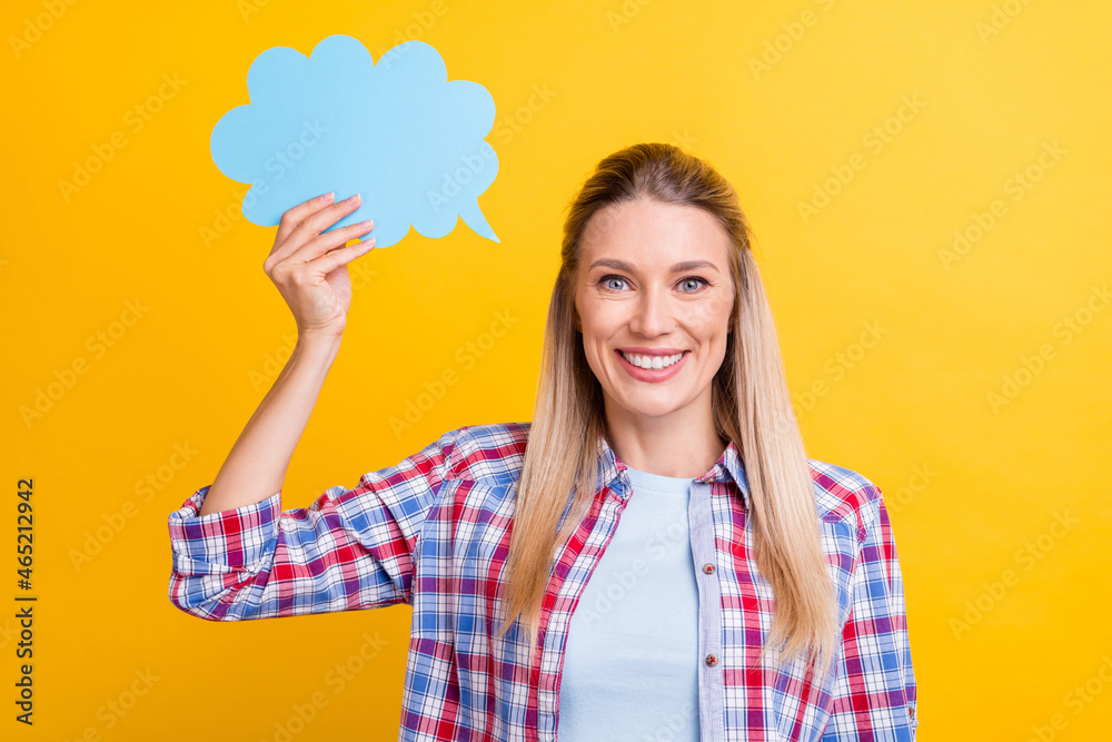 Photo of funky blond mature lady speak wear blue shirt isolated on yellow color background Photo of funky blond mature lady speak wear blue shirt isolated on yellow color background