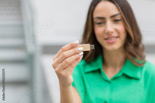 Woman holding wooden USB stick photo