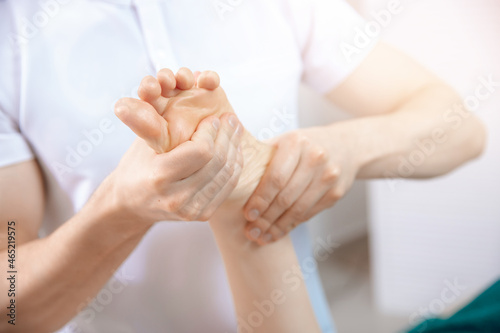 Closeup hand of therapist osteopathy working sports massage with woman foot