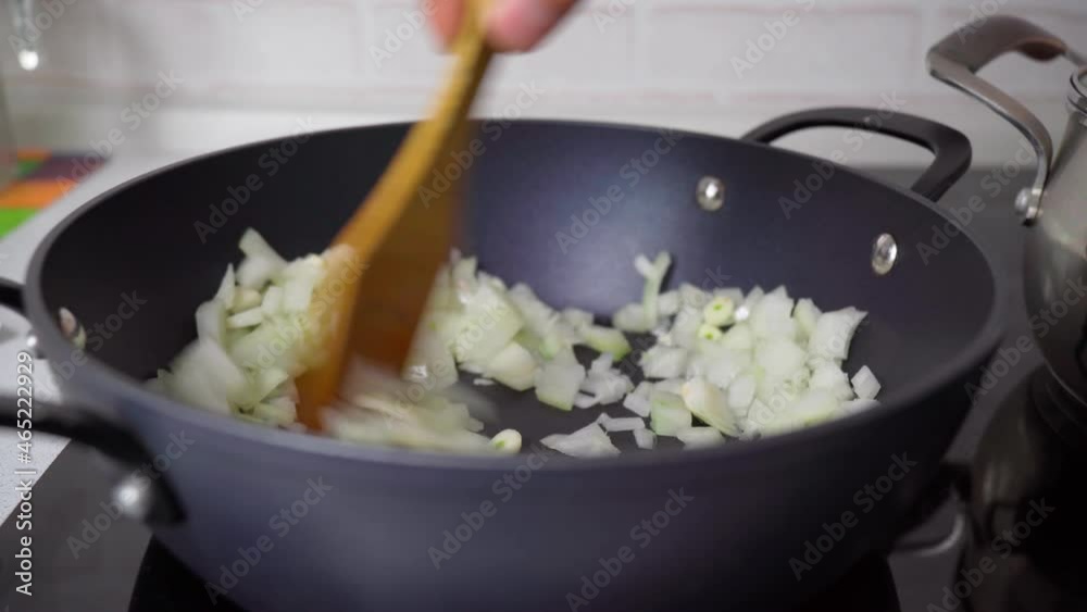 Onion in the frying pan. Preparing dinner. Cooking at home concept. Selective focus. Onion in the frying pan. Preparing dinner. Cooking at home concept. Selective focus.
