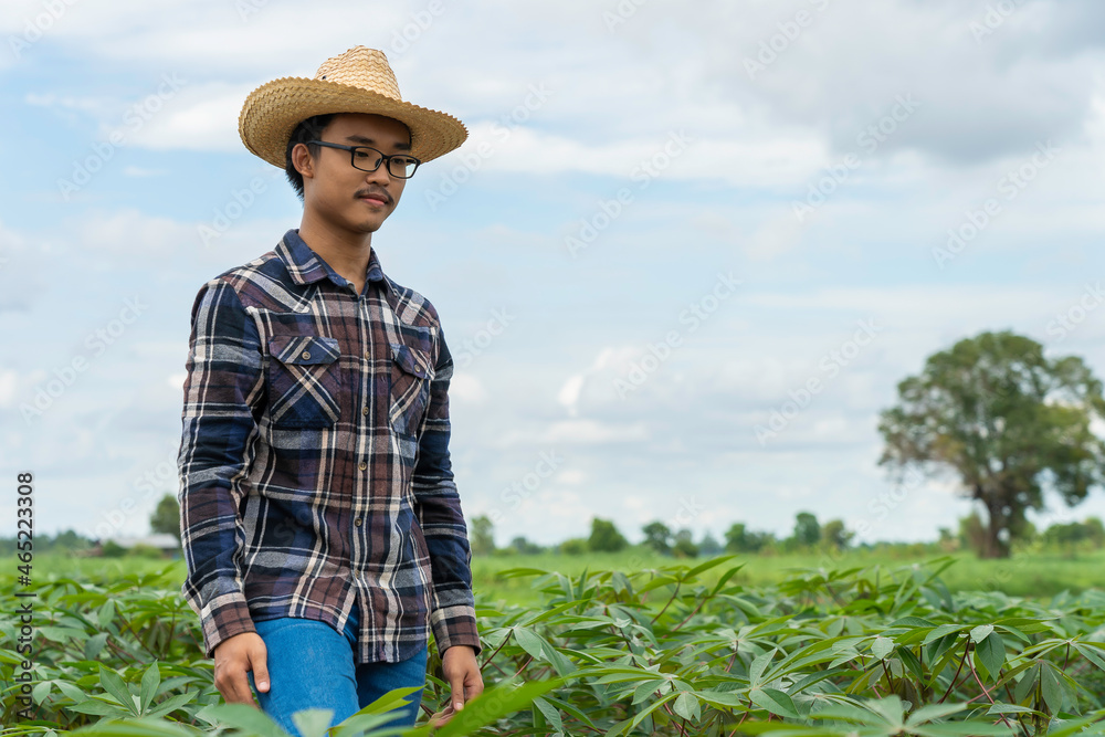 Happy Asain farmer standing in farm