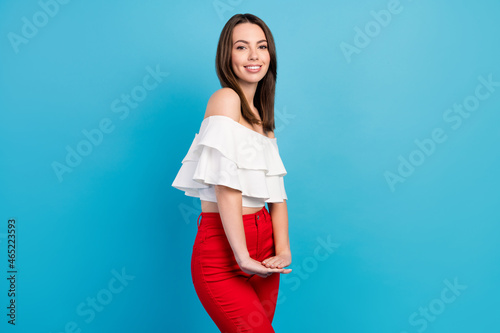 Photo of charming young adorable happy woman hold hands together smile isolated on blue color background