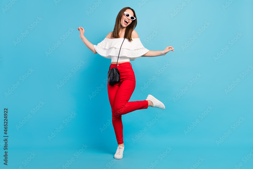 Full length body size view attractive cheerful dreamy careless girl dancing having fun isolated over vibrant blue color background
