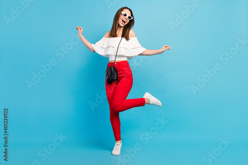 Fototapeta Naklejka Na Ścianę i Meble -  Full length body size view attractive cheerful dreamy careless girl dancing having fun isolated over vibrant blue color background