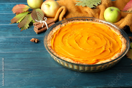 Concept of tasty food with pumpkin pie on wooden background