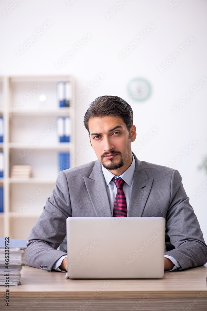 Young male employee working in the office Young male employee working in the office