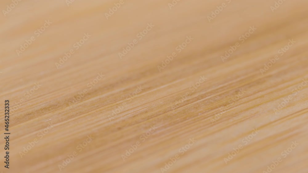 MACRO, DOF: Natural cutting board made of premium beech wood lies empty on the kitchen counter. Detailed close up shot of an empty handmade wooden cutting board. Macro view of a chef's chopping board. MACRO, DOF: Natural cutting board made of premium beech wood lies empty on the kitchen counter. Detailed close up shot of an empty handmade wooden cutting board. Macro view of a chef's chopping board.