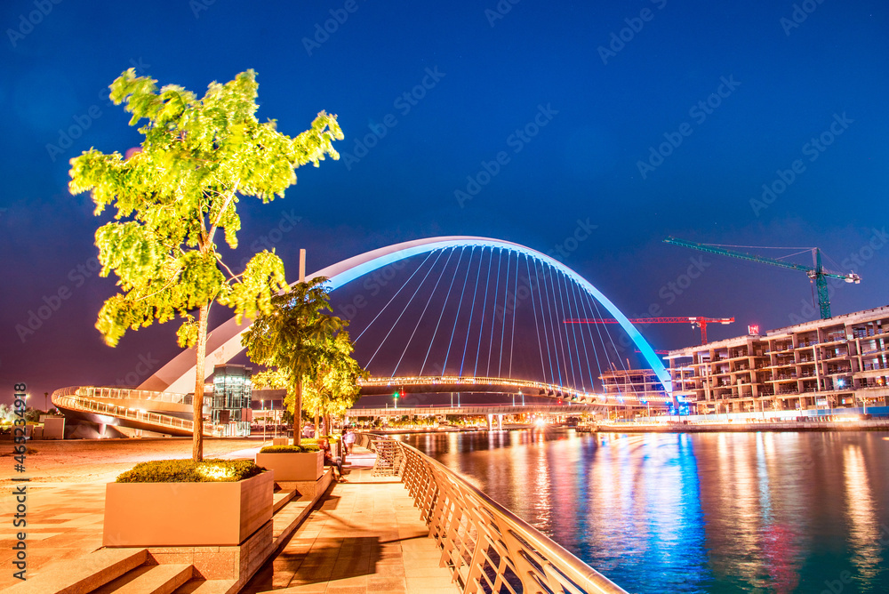 Beautiful incredible cityscape with Tolerance bridge near the water canal in Dubai, United Arab Emirates.