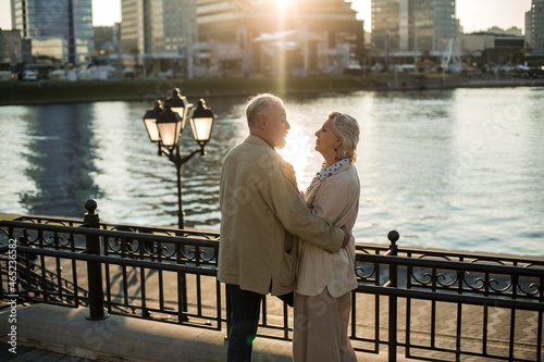 Man talking with woman while standing by railing