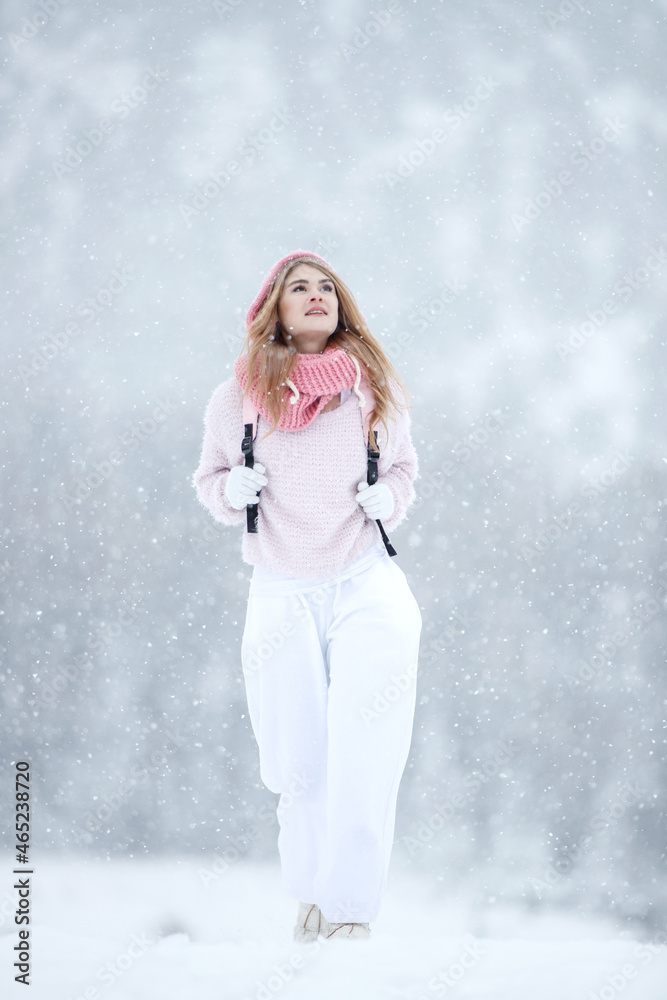 Woman in the winter in nature. A beautiful girl walks in the cold season. High quality photo Woman in the winter in nature. A beautiful girl walks in the cold season. High quality photo