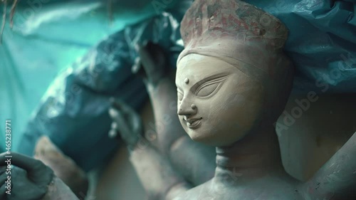 KOLKATA, INDIA - Oct 06, 2021: Beautiful unfinished idol of Goddess Durga captured from left side in a close up shot  uncolored clay model of Maa Durga captured using soft focus.