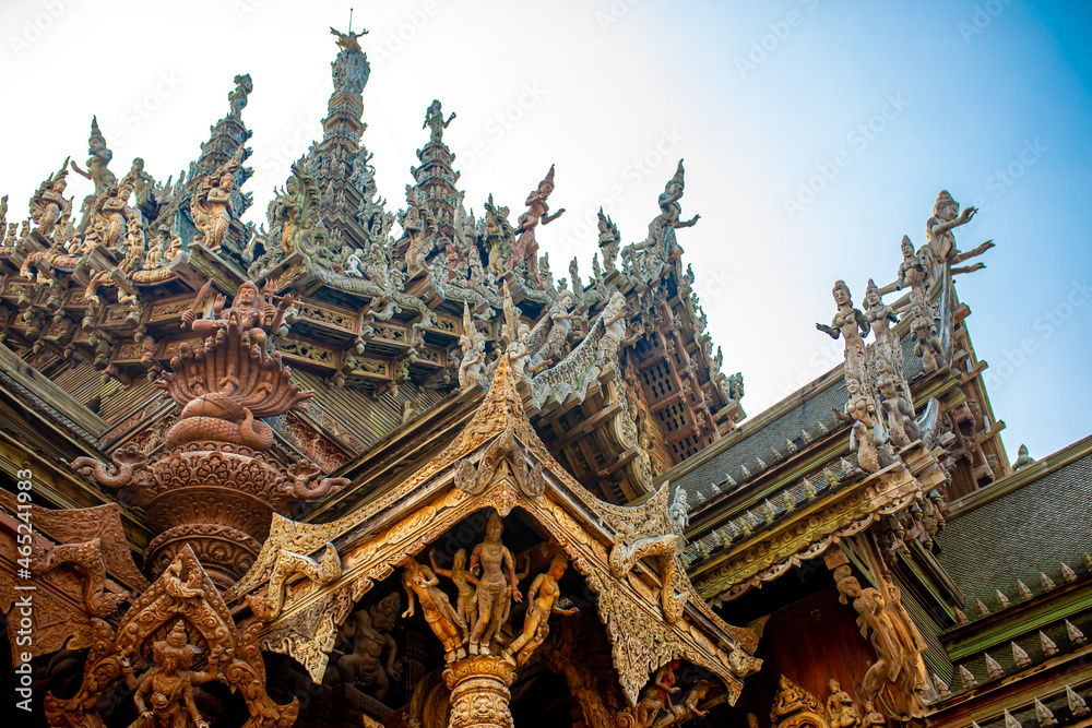 Wooden Temple in Pattaya. Traveling in Thailand. Wooden sculptures of beautiful carved patterns on the roof.