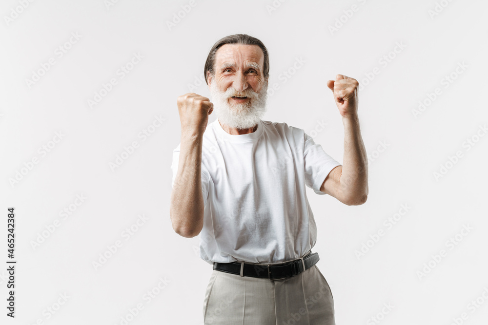 European senior man smiling while making winner gesture