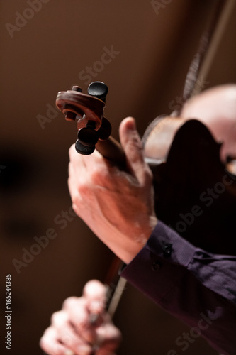 A viola or violin player during a performance or a rehearsal