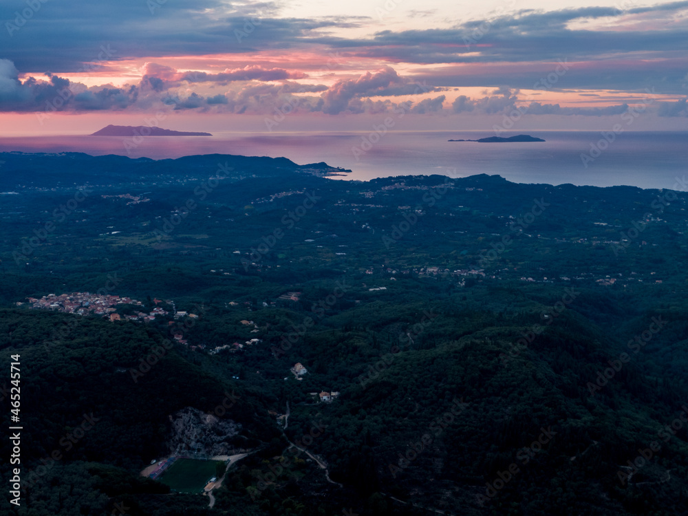 Aerial drone shot of sunset over the mountain in corfu island