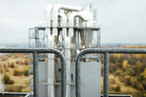 view of the factory pipes and workshops. working industrial production. harmful emissions of gases from pipes. metallurgical plant. communications and production lines