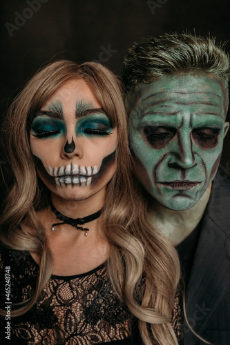 The image of a skeleton girl and the image of a Frankenstein man on Halloween in the dark. an image for a couple on Halloween. large paired portrait with closed eyes